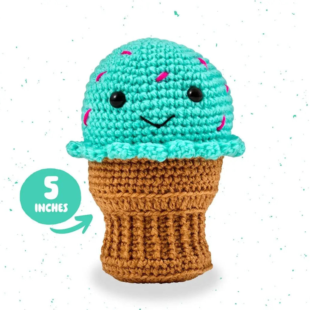 Crocheted ice cream cone toy with turquoise top and brown base on a white background
