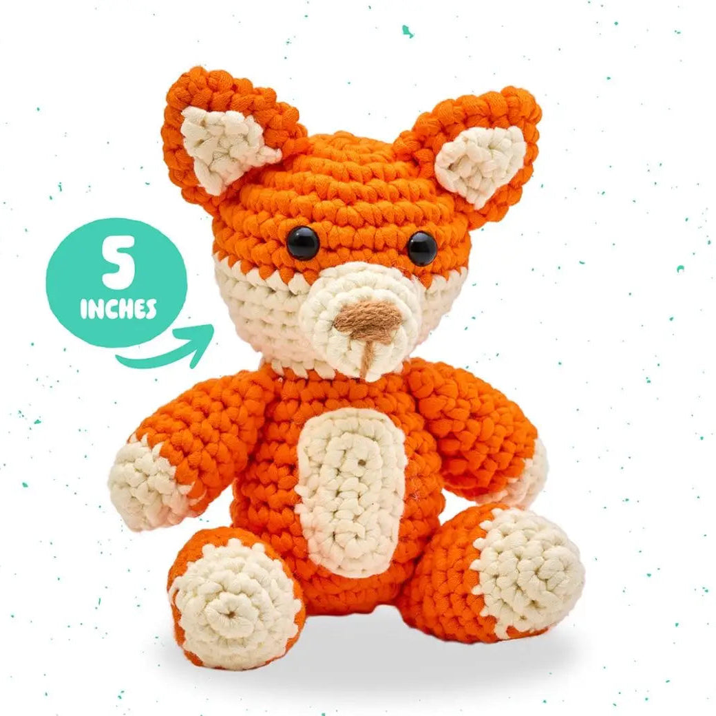 Crocheted fox toy with size indicator and product code on a white background
